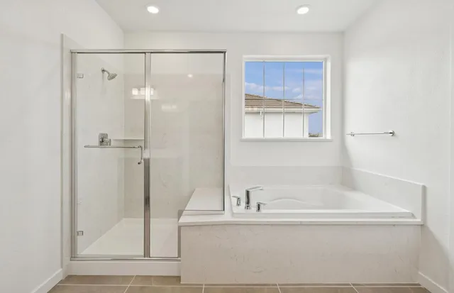 a bathroom with a bathtub and a shower