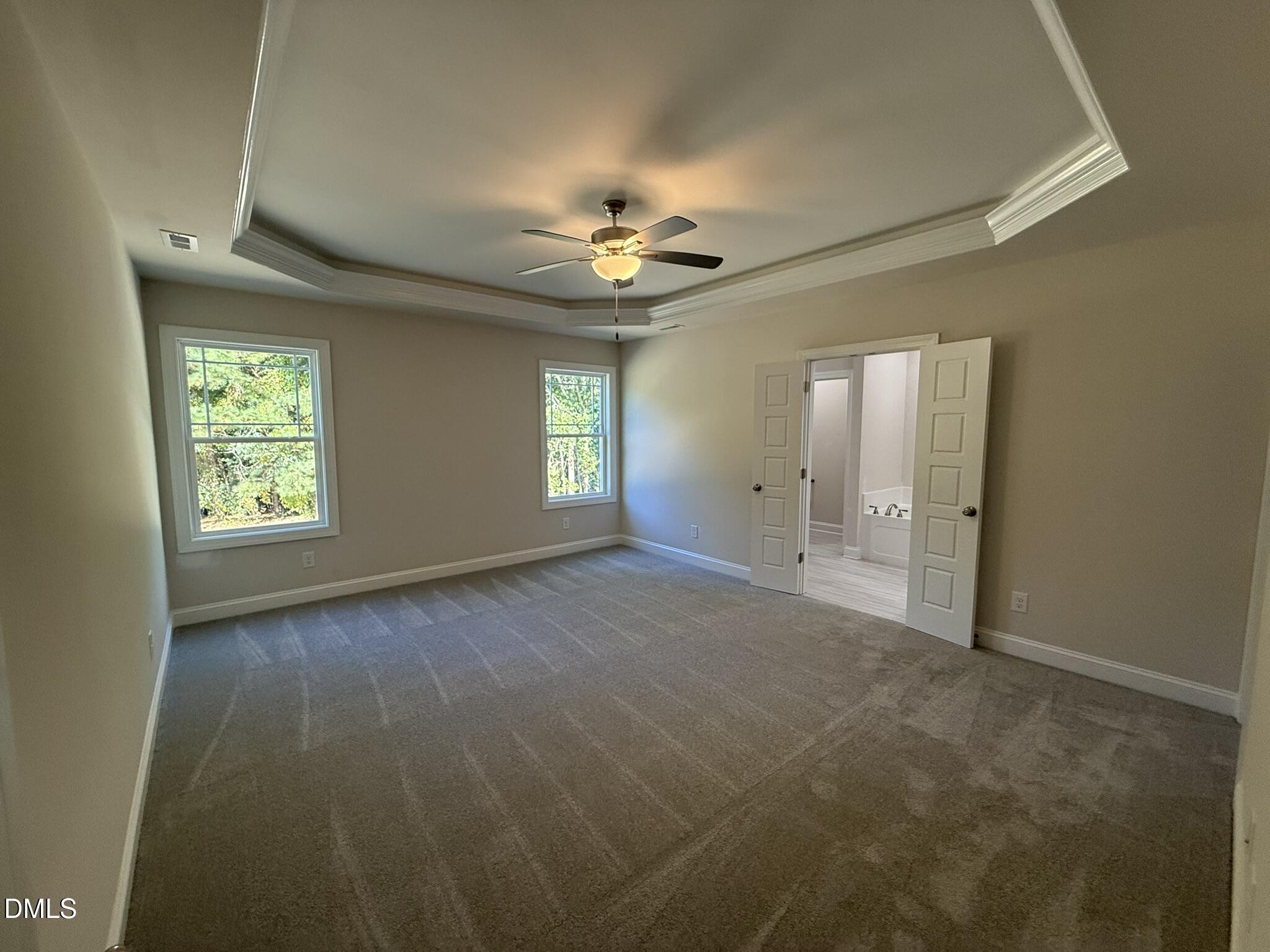 309 Busterfield Court Benson, NC 27504 - Photo 12 of 27 an empty room with windows and fan