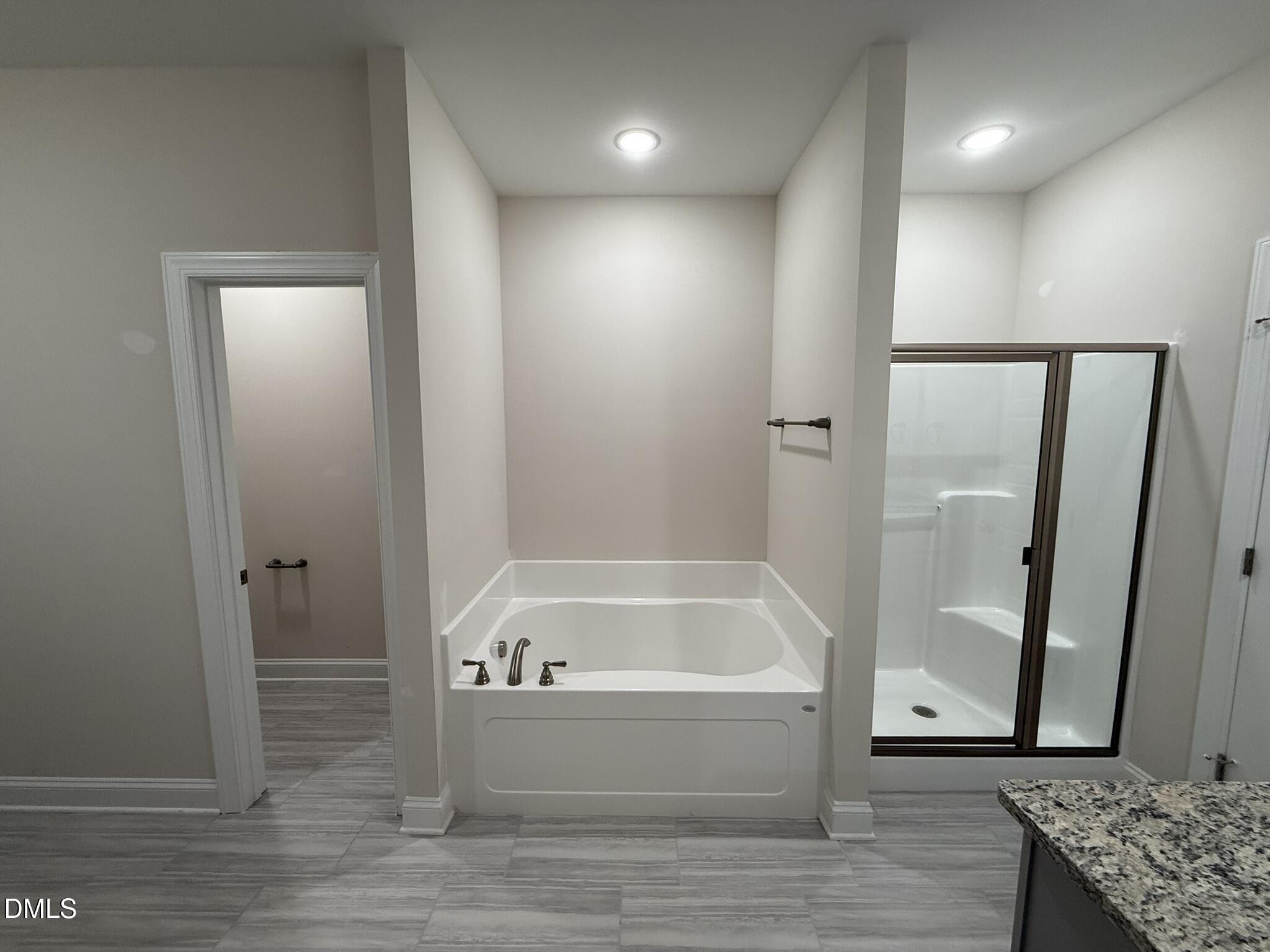 309 Busterfield Court Benson, NC 27504 - Photo 15 of 27 a bathroom with a tub and shower