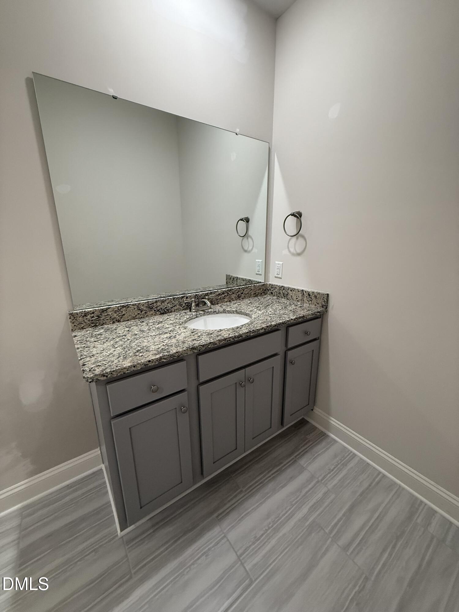 309 Busterfield Court Benson, NC 27504 - Photo 17 of 27 a bathroom with a granite countertop sink and a mirror