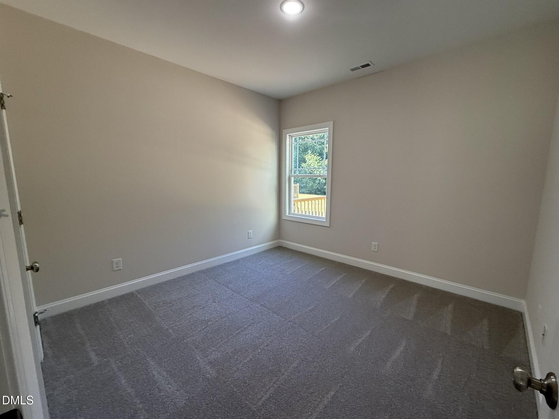 309 Busterfield Court Benson, NC 27504 - Photo 19 of 27 an empty room with windows
