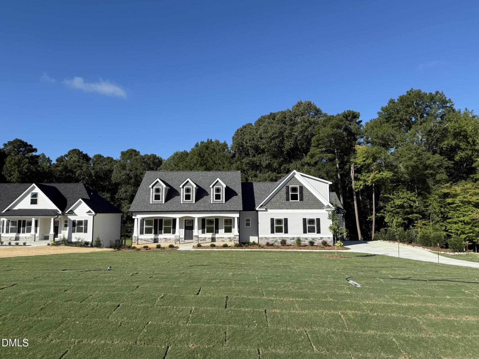309 Busterfield Court Benson, NC 27504 - Photo 2 of 27 a front view of a house with a garden