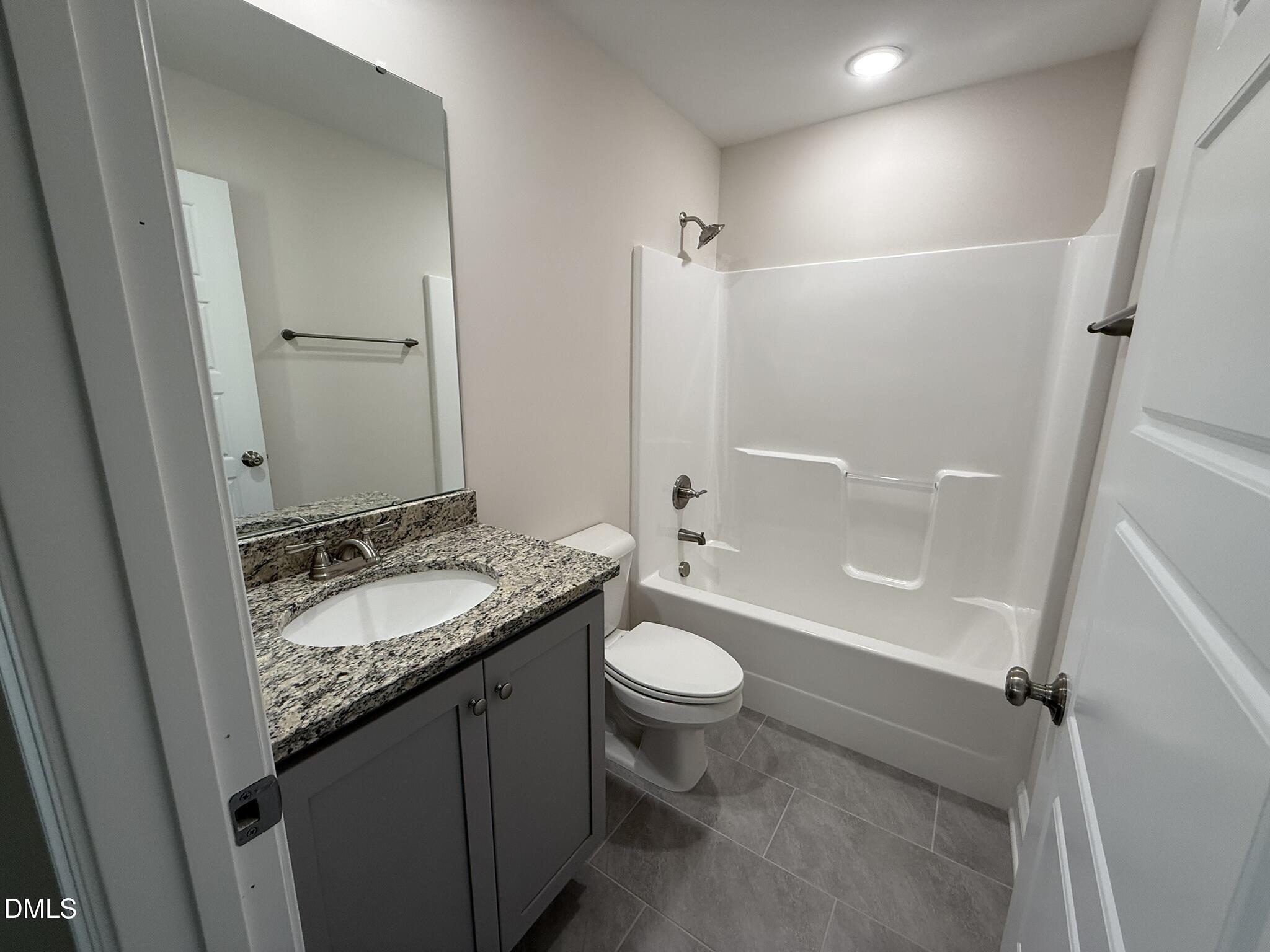 309 Busterfield Court Benson, NC 27504 - Photo 23 of 27 a bathroom with a granite countertop sink toilet and shower