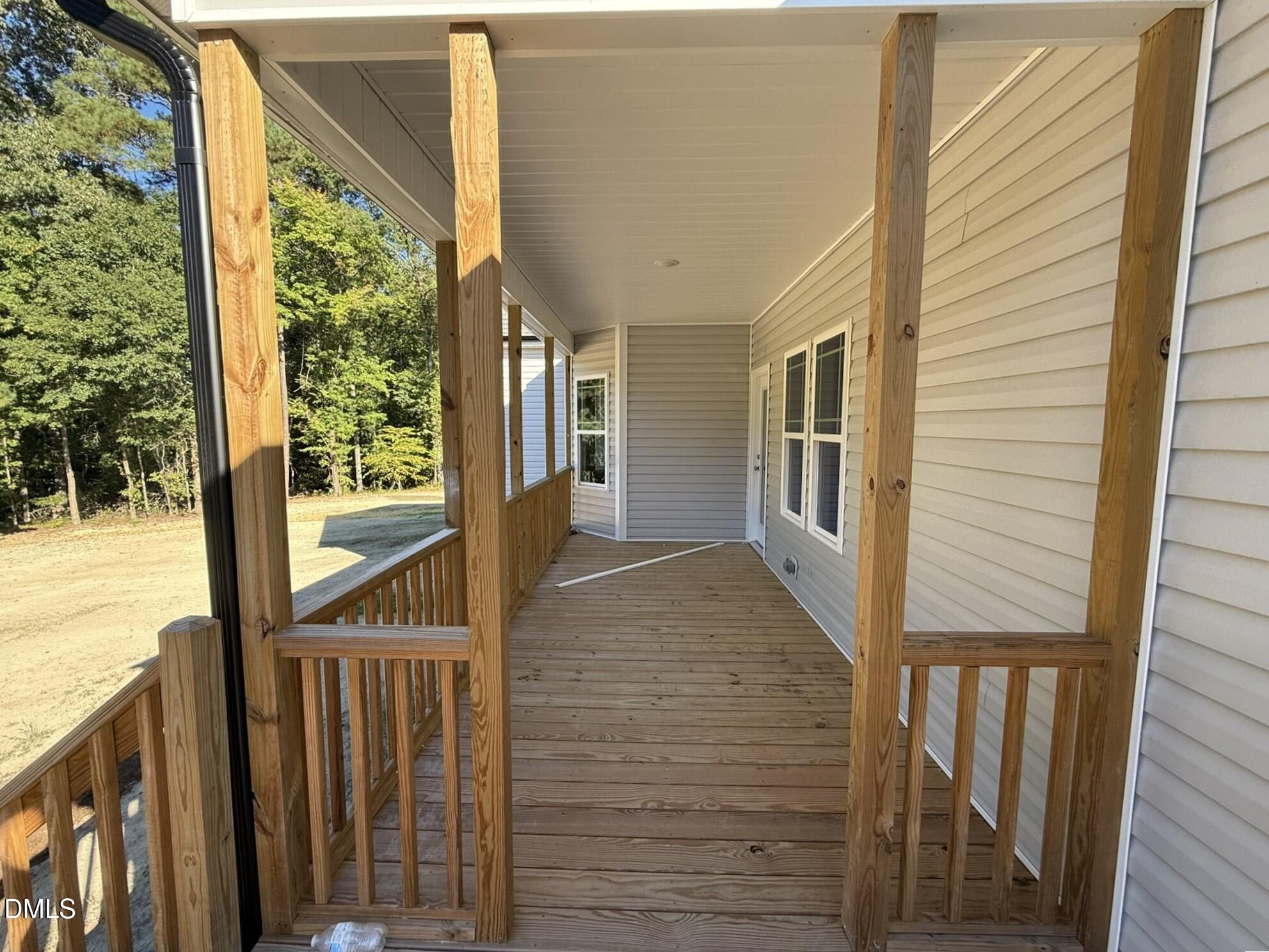 309 Busterfield Court Benson, NC 27504 - Photo 24 of 27 a view of a porch with wooden floor and outdoor space