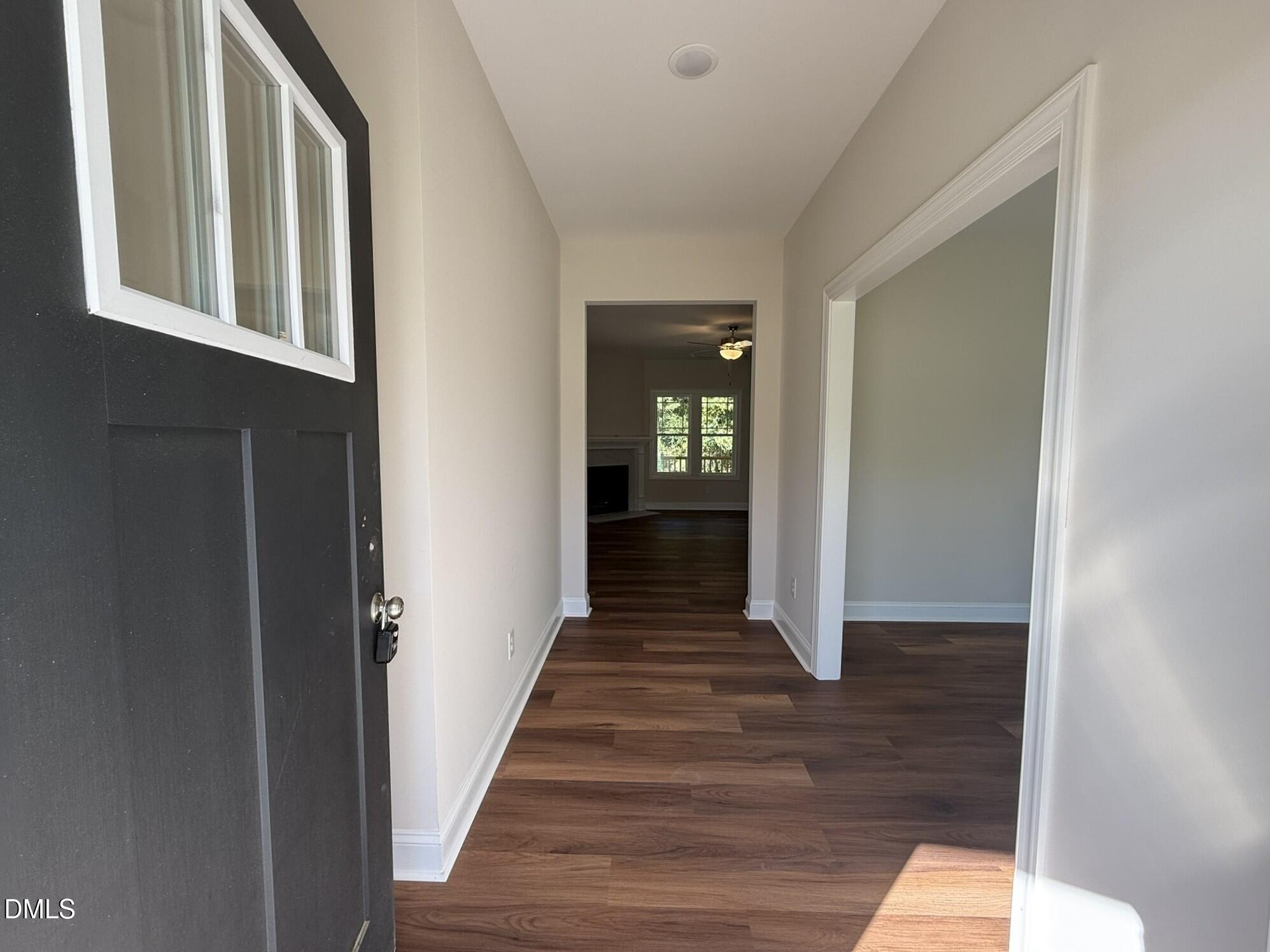 309 Busterfield Court Benson, NC 27504 - Photo 4 of 27 a view of a hallway with wooden floor and staircase