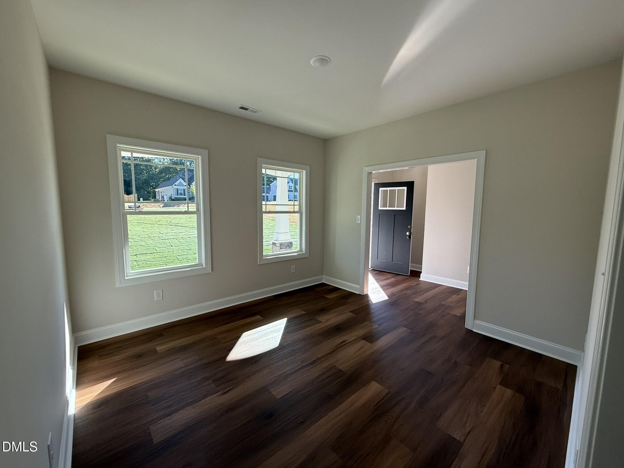 309 Busterfield Court Benson, NC 27504 - Photo 5 of 27 a view of empty room with wooden floor and fan