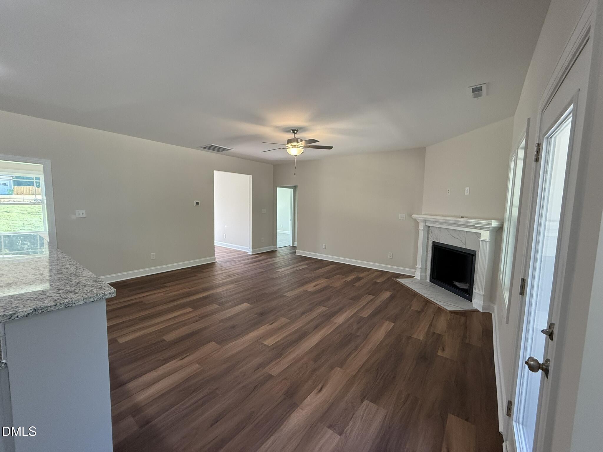 309 Busterfield Court Benson, NC 27504 - Photo 7 of 27 a view of a livingroom with wooden floor and a fireplace