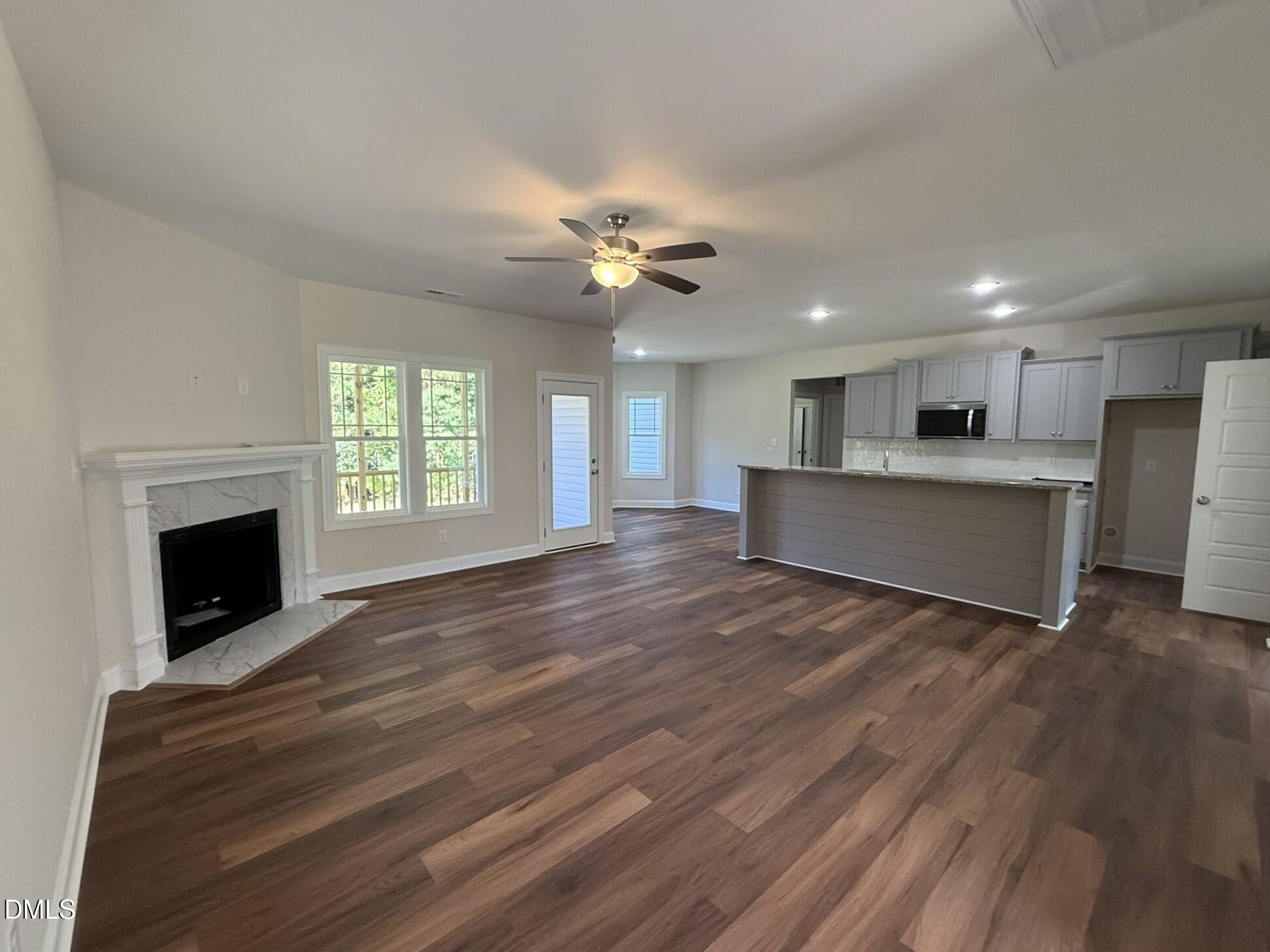 309 Busterfield Court Benson, NC 27504 - Photo 8 of 27 a view of an empty room with a fireplace and a window
