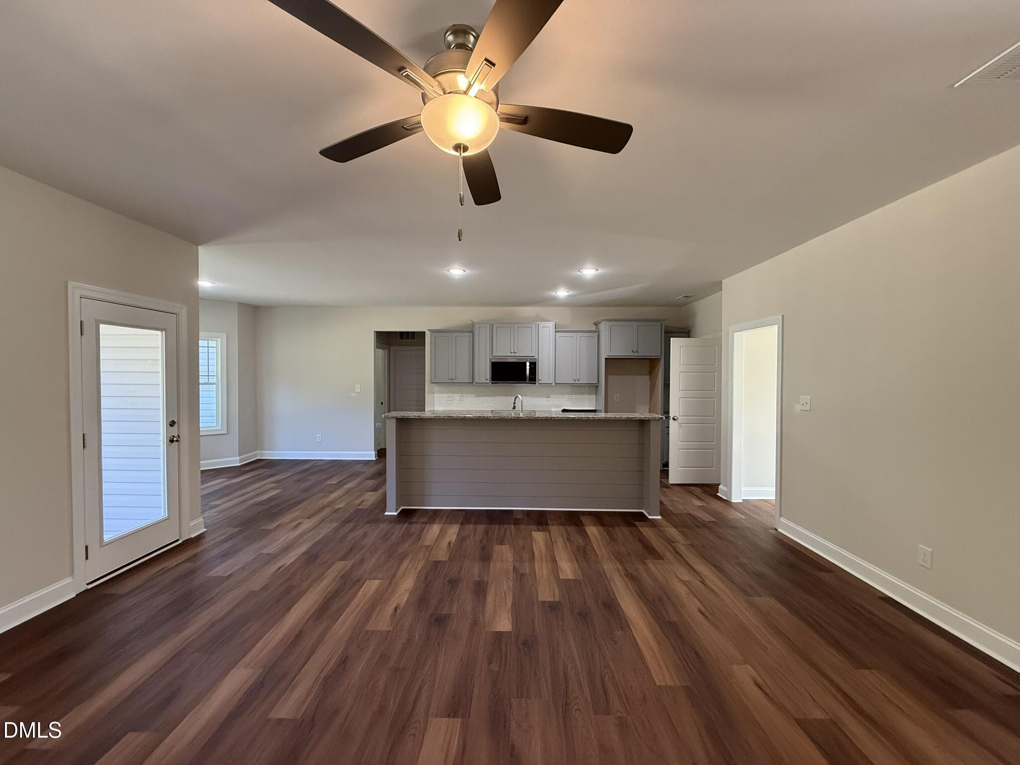 309 Busterfield Court Benson, NC 27504 - Photo 9 of 27 a living room with wooden floors and ceiling fan