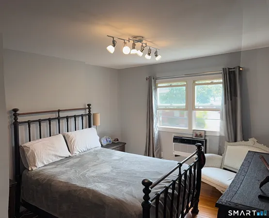 a bedroom with a bed and a chandelier