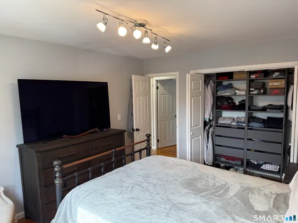 a bedroom with a bed and a flat screen tv