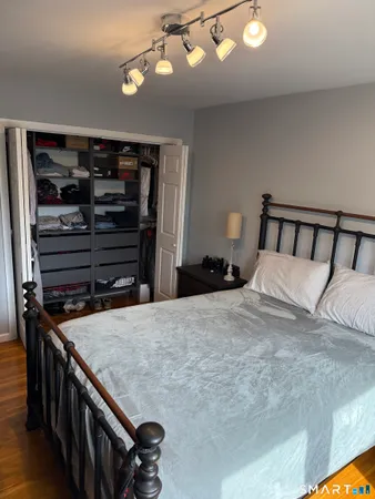 a bedroom with a bed and cabinets