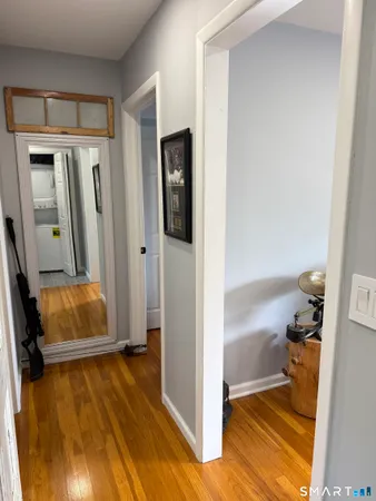 a bathroom with a tub and a hallway