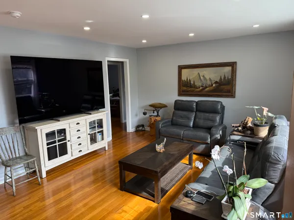 a living room with furniture and a flat screen tv