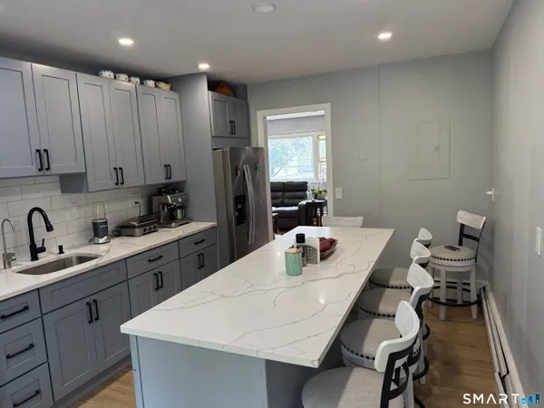 a kitchen with a sink a stove and refrigerator