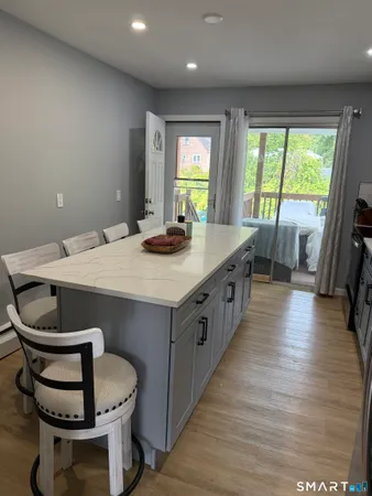 a kitchen with a sink stove and wooden floor