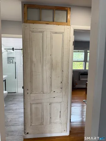 a view of hallway with wooden floor