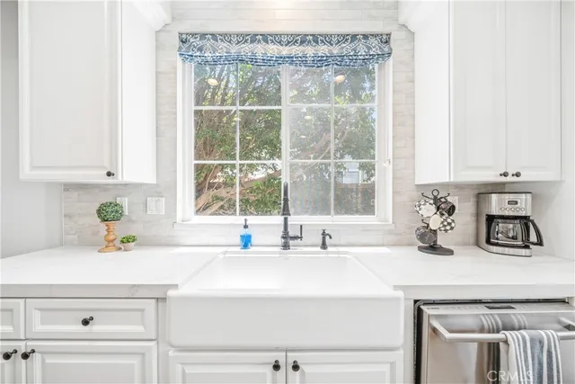 a view of staircase with lots of frames on wall and a large window