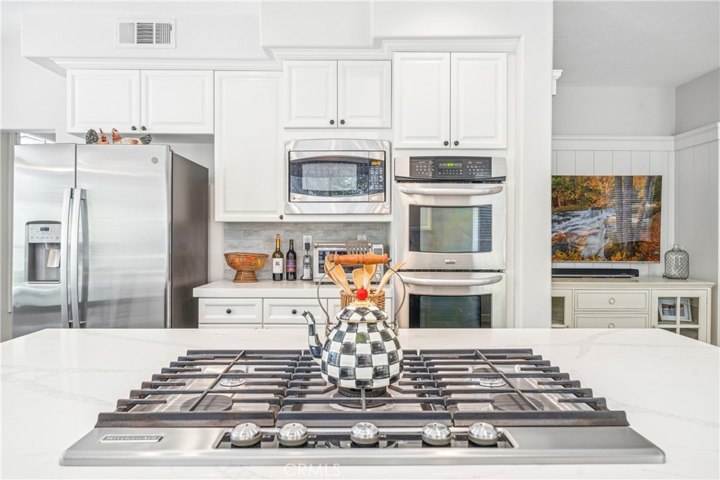 22681 Maplewood Mission Viejo, CA 92692 - Photo 17 of 71 a kitchen with stainless steel appliances granite countertop a stove and a refrigerator