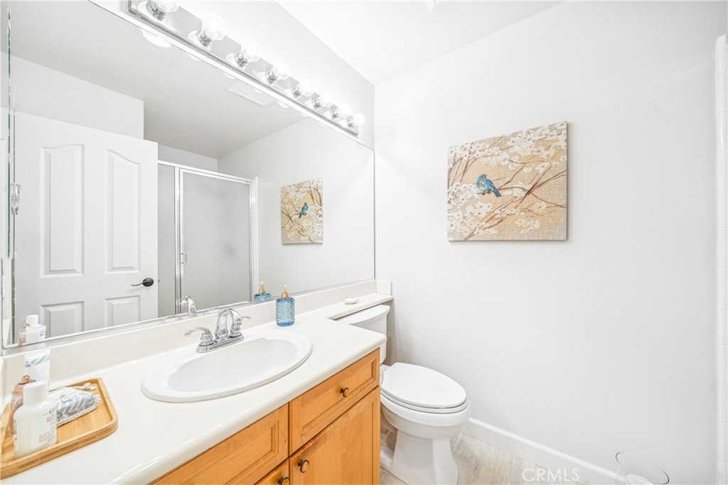 22681 Maplewood Mission Viejo, CA 92692 - Photo 21 of 71 a bathroom with a toilet a sink and a mirror