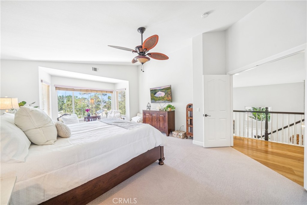 22681 Maplewood Mission Viejo, CA 92692 - Photo 25 of 71 a bedroom with a bed and a chandelier
