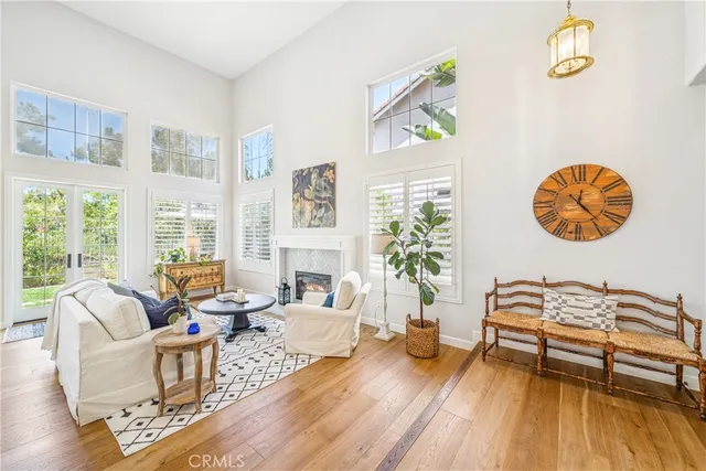 a living room with patio furniture and a wooden floor