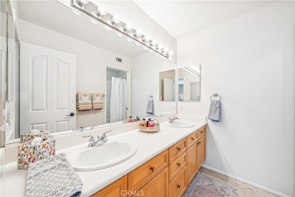 22681 Maplewood Mission Viejo, CA 92692 - Photo 35 of 71 a bathroom with a double vanity sink and mirror