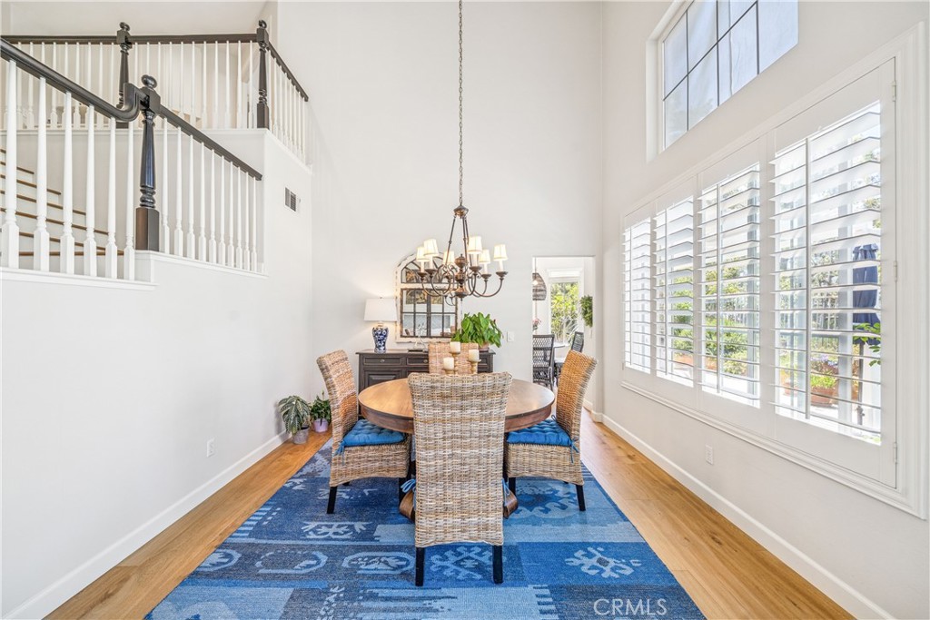 22681 Maplewood Mission Viejo, CA 92692 - Photo 7 of 71 a dining room with furniture a rug and wooden floor