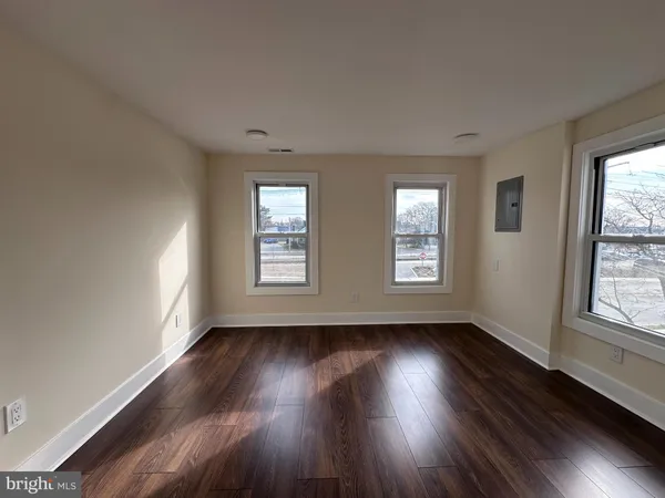 a view of room with hardwood floor and windows