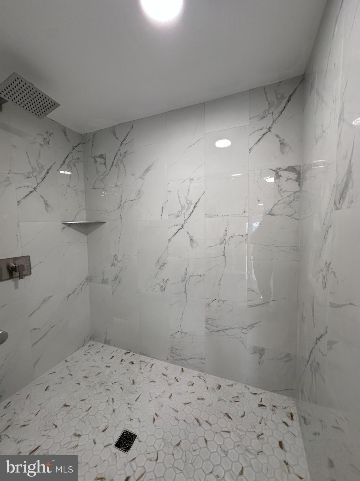 1019 North Broad Street Woodbury, NJ 08096 - Photo 25 of 37 Sleek marble shower with elegant design.