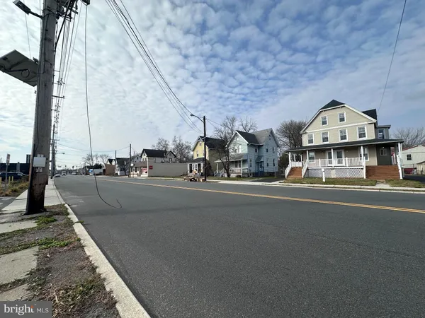 a view of a street with cars parked