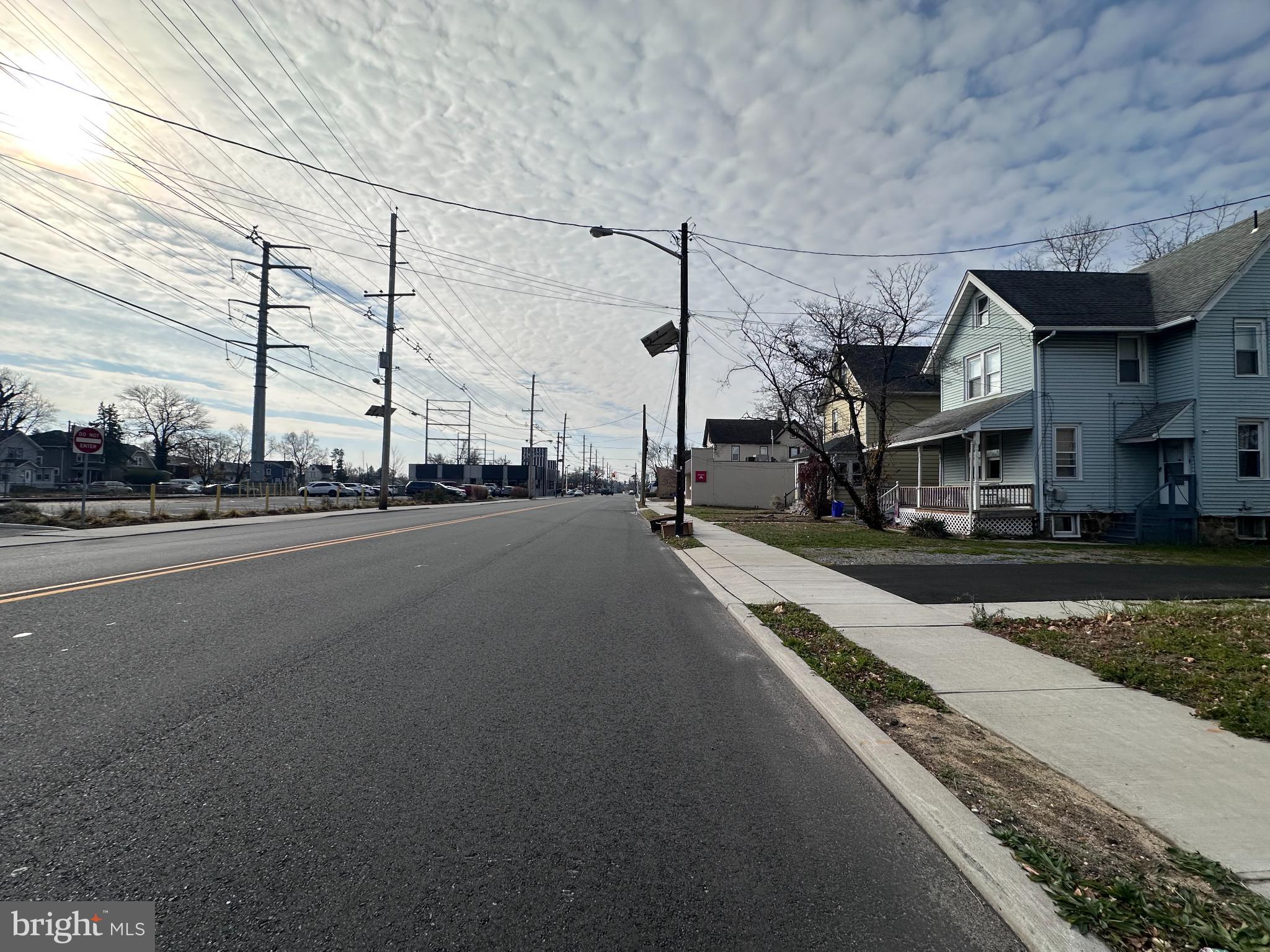 1019 North Broad Street Woodbury, NJ 08096 - Photo 30 of 37 Quiet street under a vast, cloudy sky.