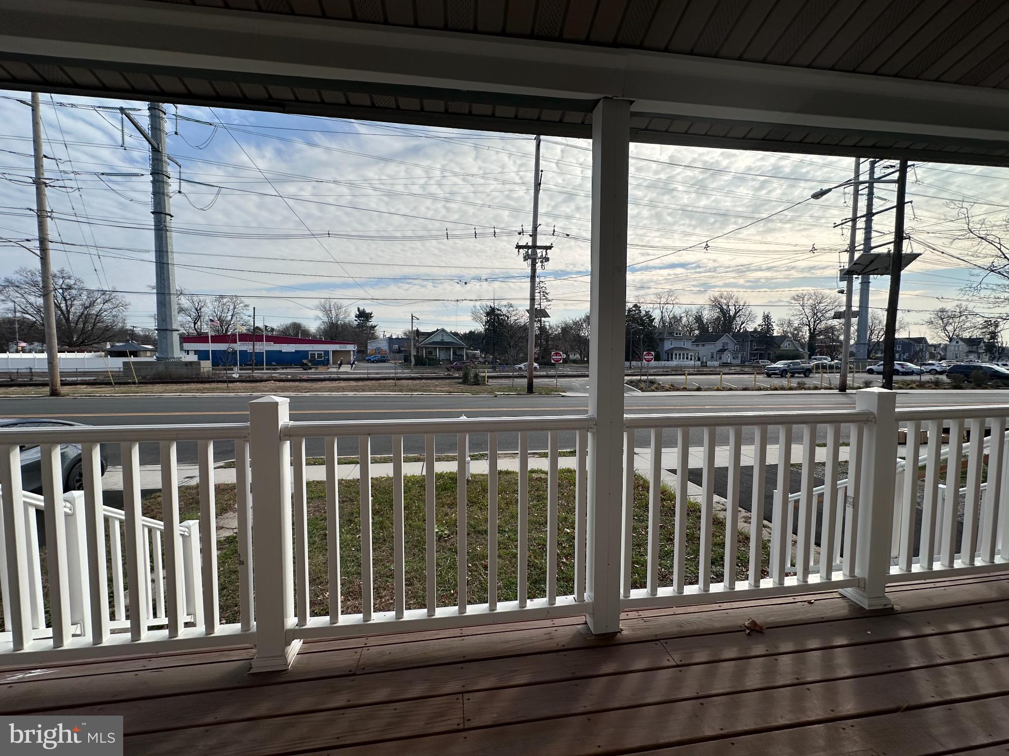 1019 North Broad Street Woodbury, NJ 08096 - Photo 35 of 37 Charming porch view of a bustling street.