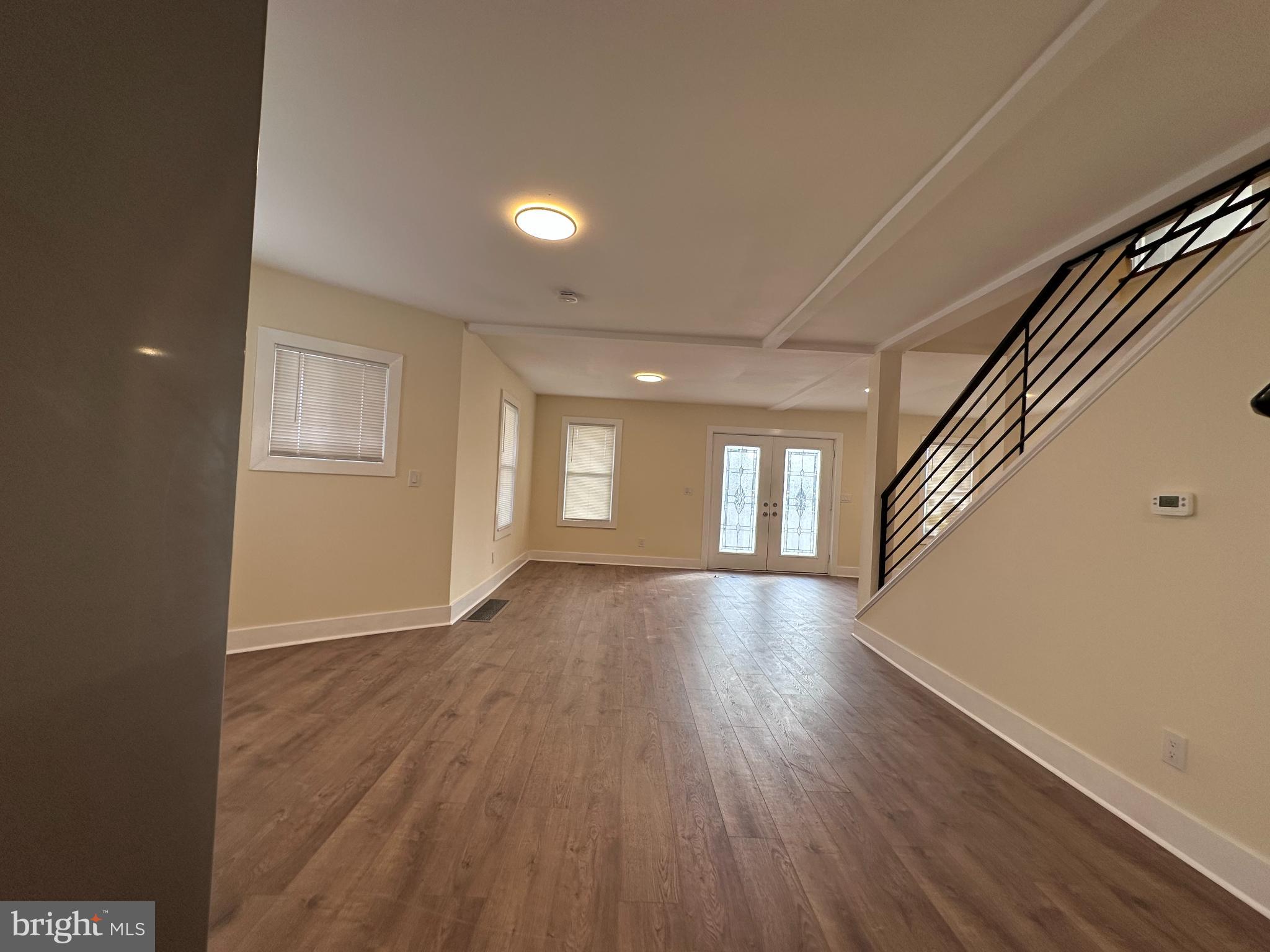 1019 North Broad Street Woodbury, NJ 08096 - Photo 4 of 37 Spacious, sunlit living area with modern flair.