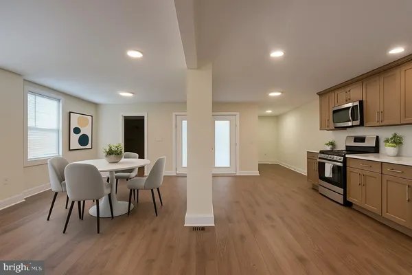 a view of a dining room with furniture and wooden floor