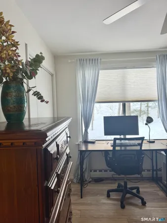 a view of a dirt road with trees in the background