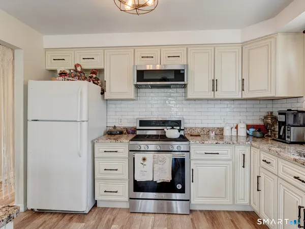 a view of a dirt road with trees in the background