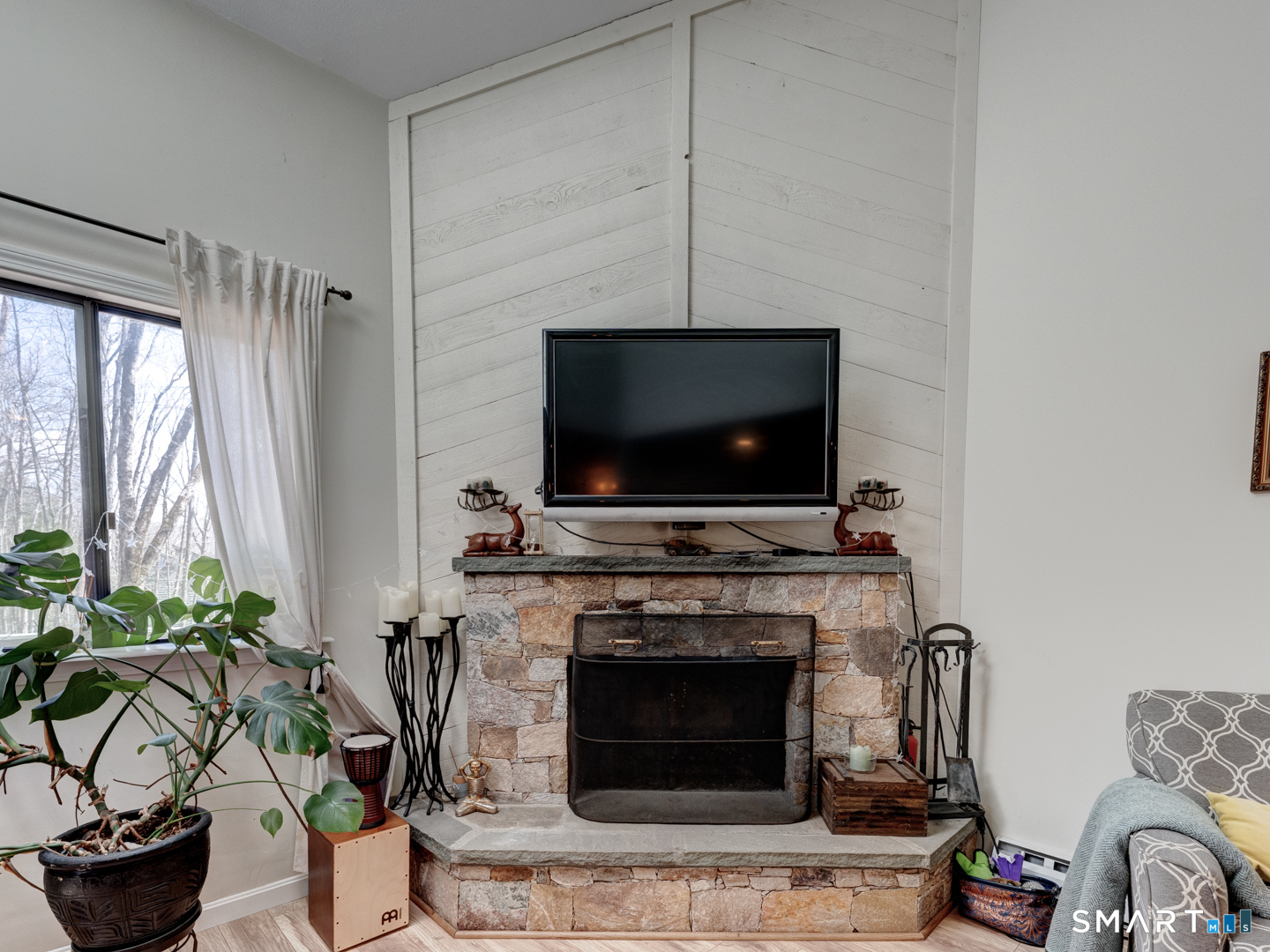 355 Ledge Drive, Unit 355 Torrington, CT 06790 - Photo 23 of 58 a living room with furniture a flat screen tv and a fireplace
