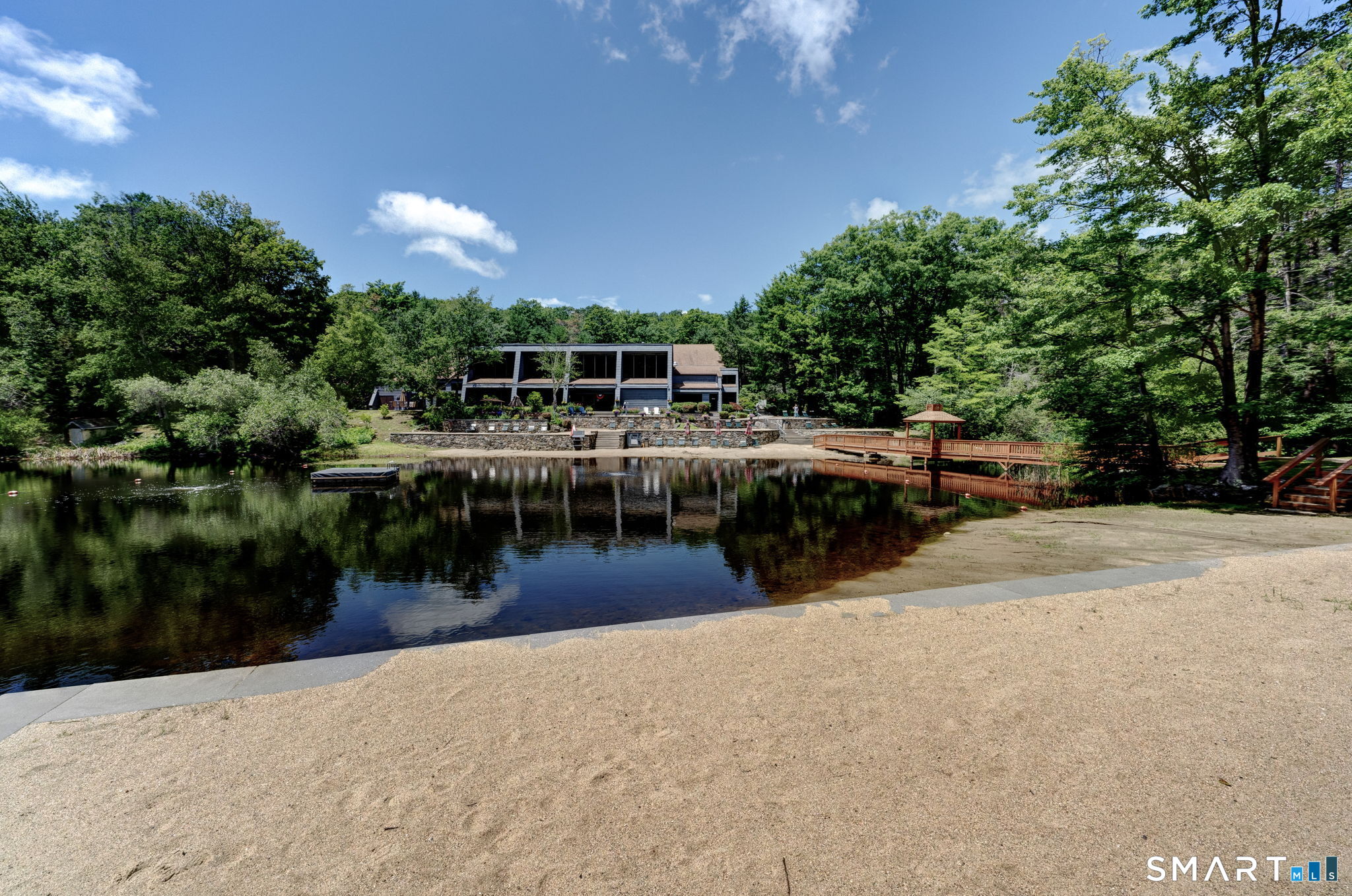 355 Ledge Drive, Unit 355 Torrington, CT 06790 - Photo 23 of 34 a view of a lake with a house in the background