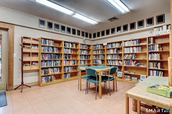 a view of a tennis ground with large trees