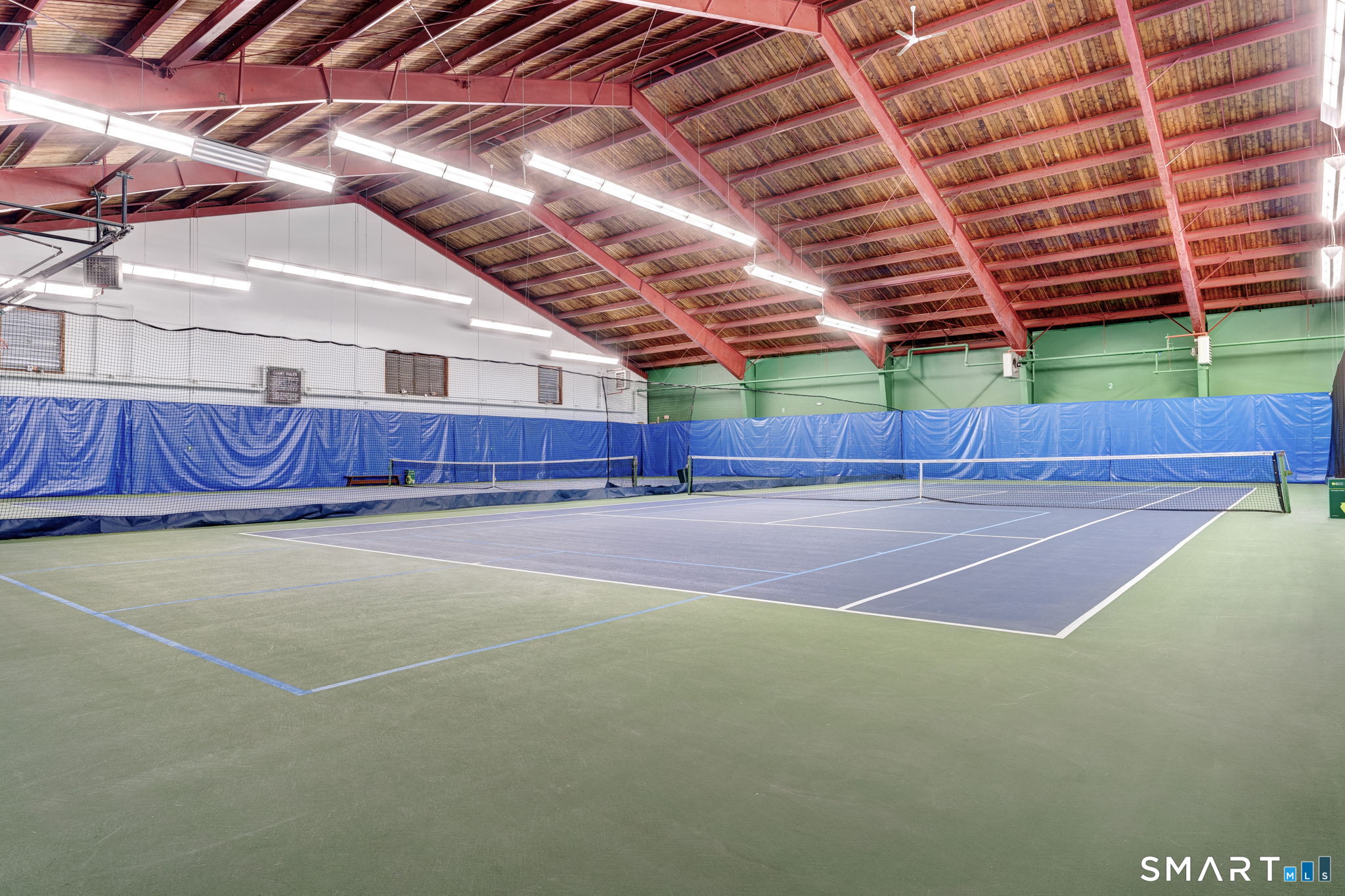 355 Ledge Drive, Unit 355 Torrington, CT 06790 - Photo 30 of 34 a view of a tennis ground with large trees