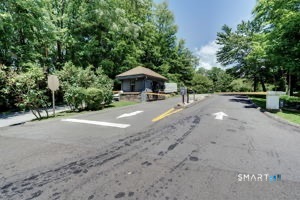 355 Ledge Drive, Unit 355 Torrington, CT 06790 - Photo 34 of 58 a view of a dirt road with trees in the background