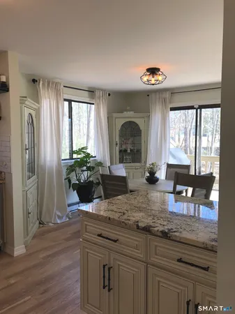 a large bed sitting in a bedroom next to a window