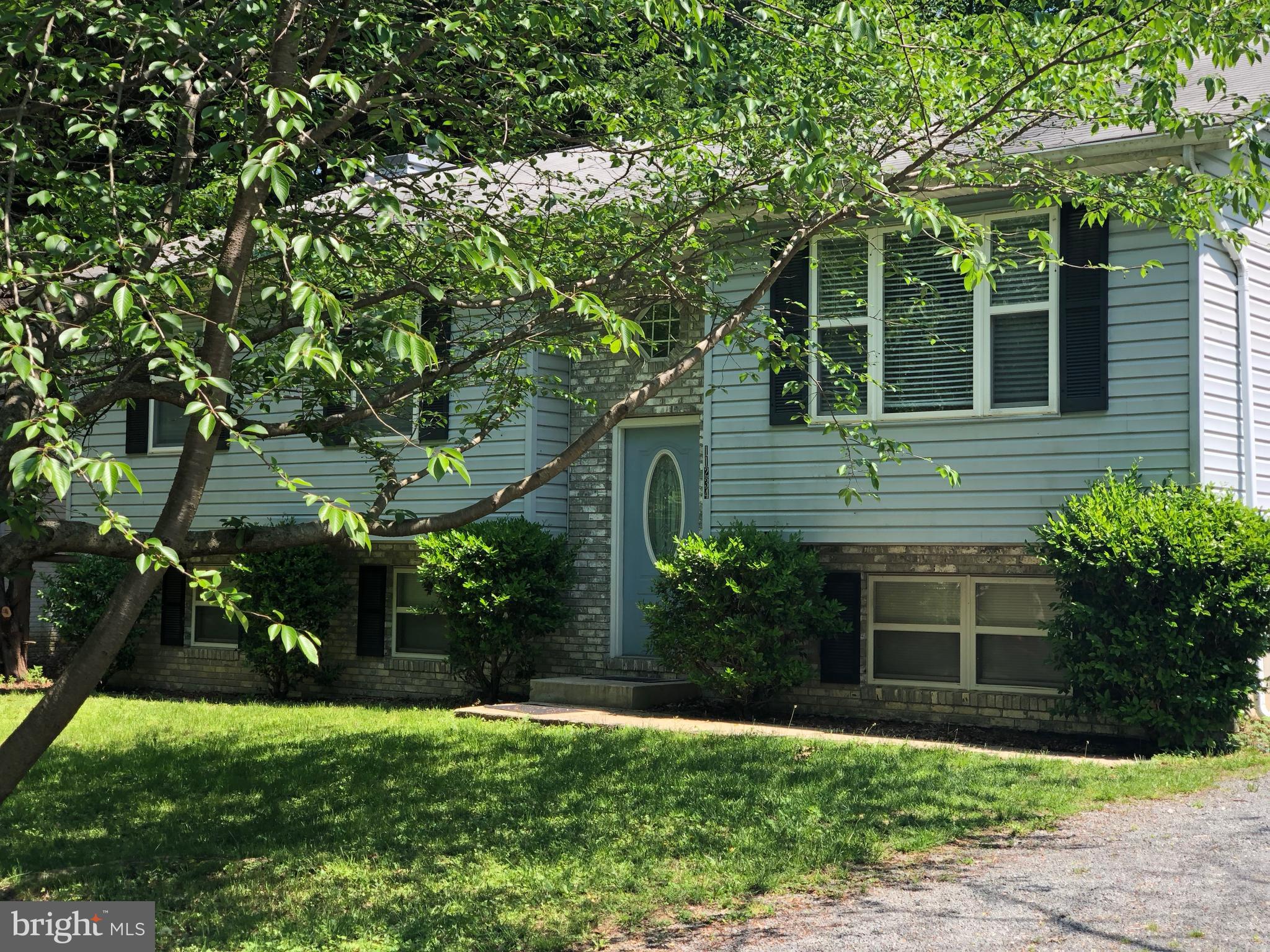 11234 Commanche Road Lusby, MD 20657 - Photo 1 of 21 a front view of a house with a yard