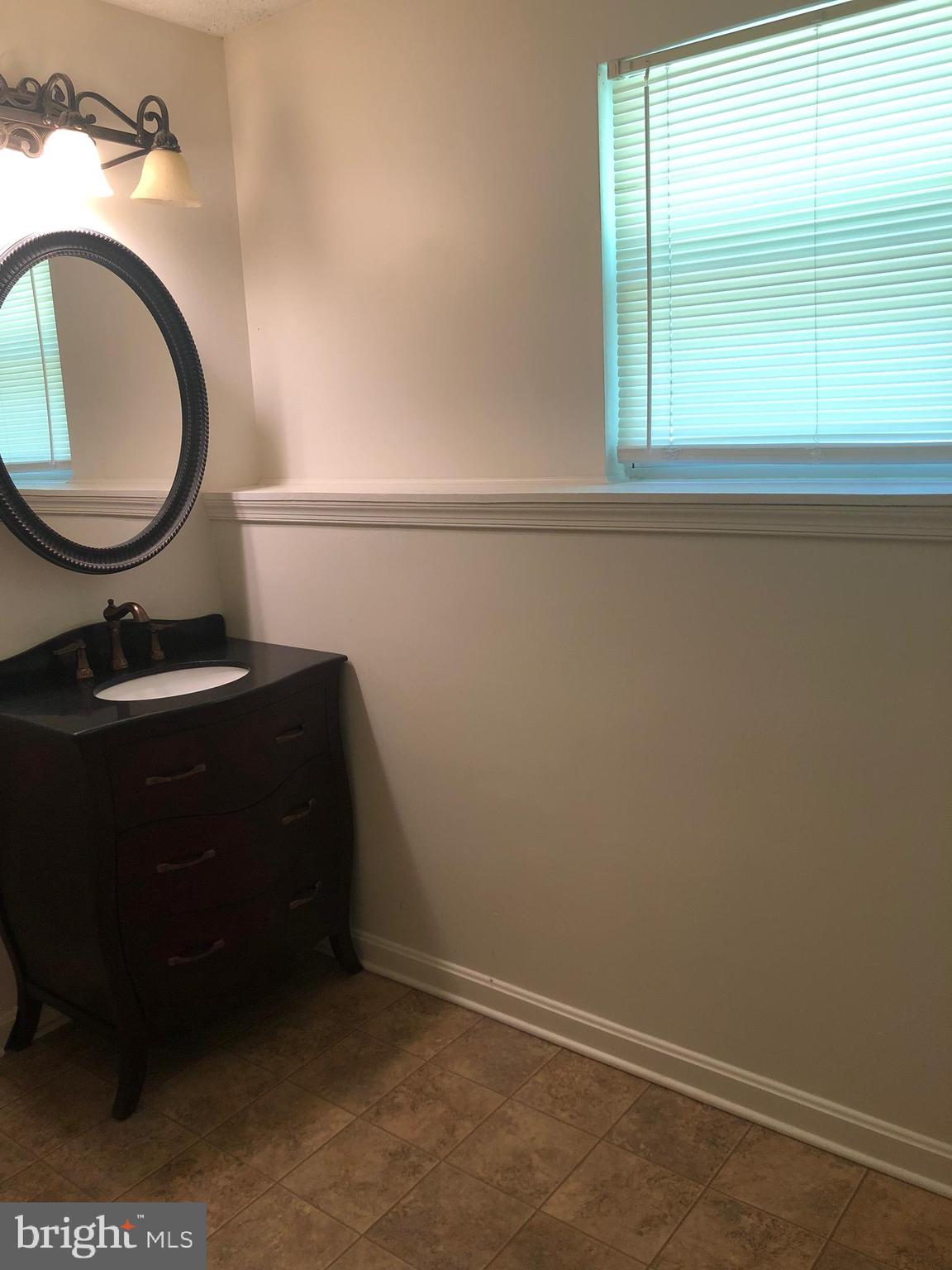 11234 Commanche Road Lusby, MD 20657 - Photo 15 of 21 a bathroom with a toilet a sink and mirror