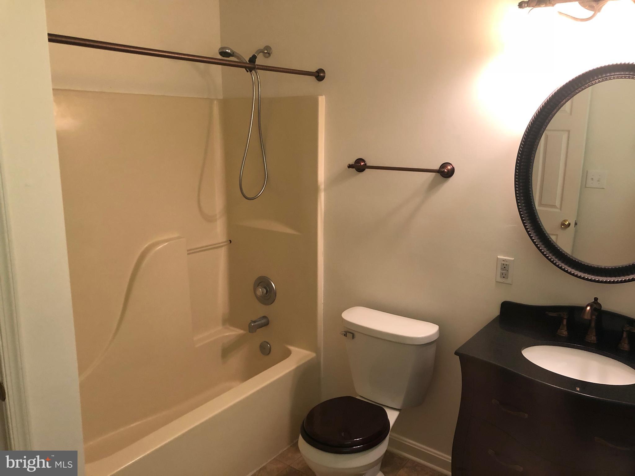 11234 Commanche Road Lusby, MD 20657 - Photo 16 of 21 a bathroom with a sink a toilet and a mirror
