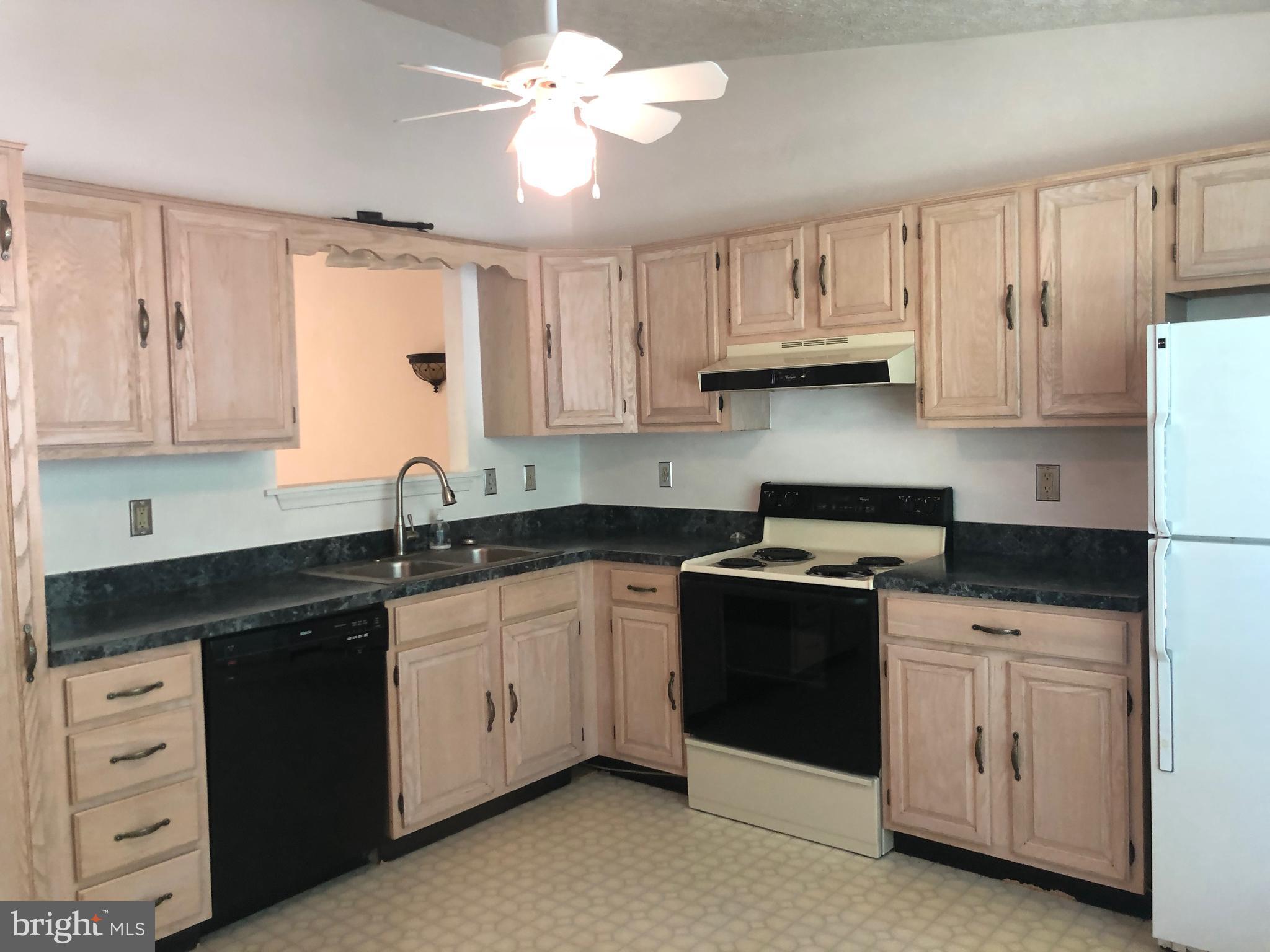 11234 Commanche Road Lusby, MD 20657 - Photo 4 of 21 a kitchen with stainless steel appliances granite countertop a sink stove and cabinets