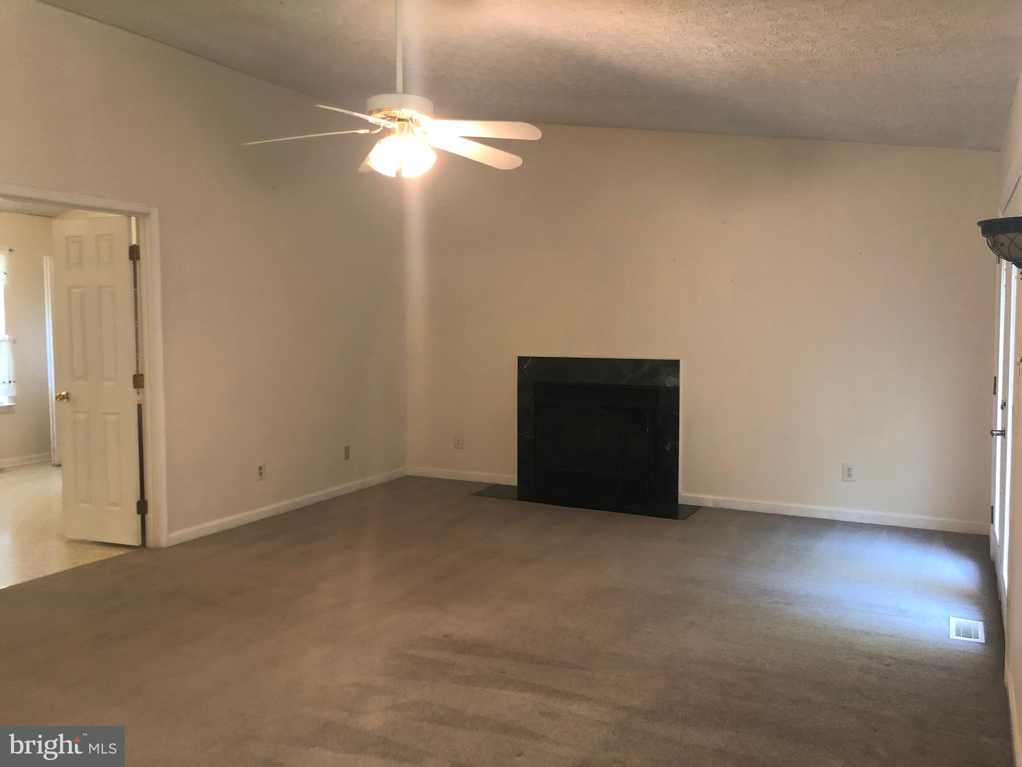 11234 Commanche Road Lusby, MD 20657 - Photo 7 of 21 an empty room with a chandelier fan