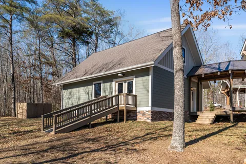 a view of a house with a wooden fence