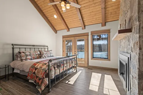 a bedroom with a bed and wooden floor